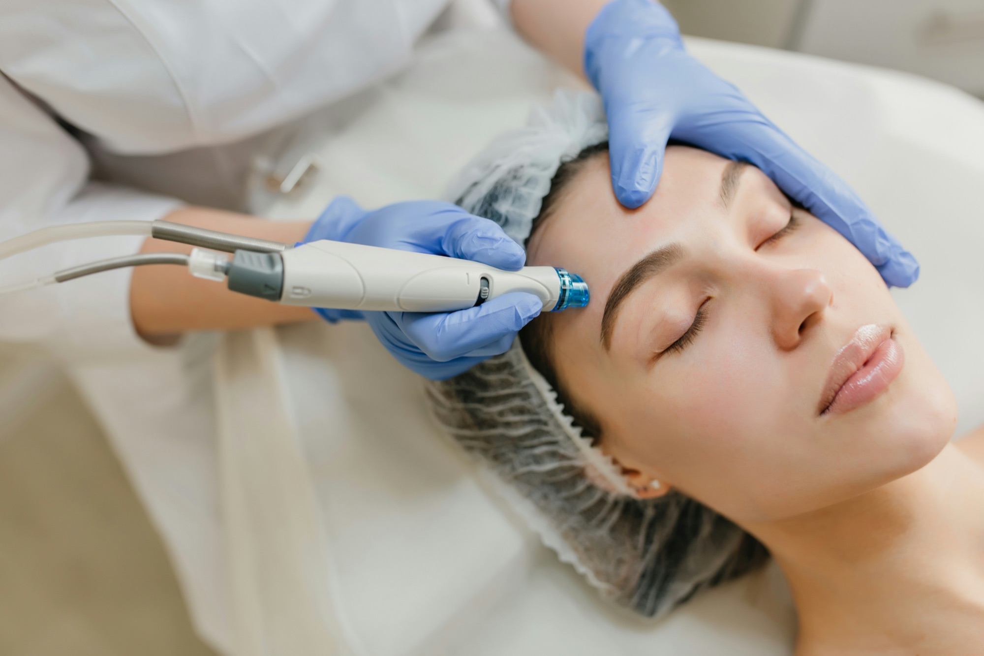 Aesthetic clinician carrying out a skin treatment